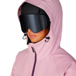 Women's insulated ski jacket, light pink hood up, goggles and face close-up