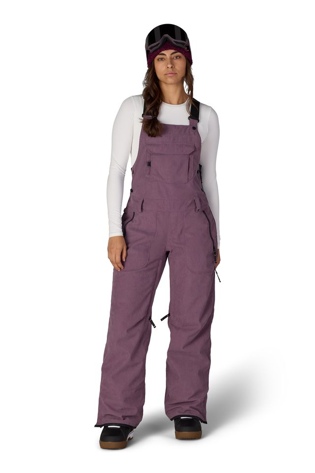 Women’s insulated bib overalls in mauve purple with front pockets and adjustable straps.