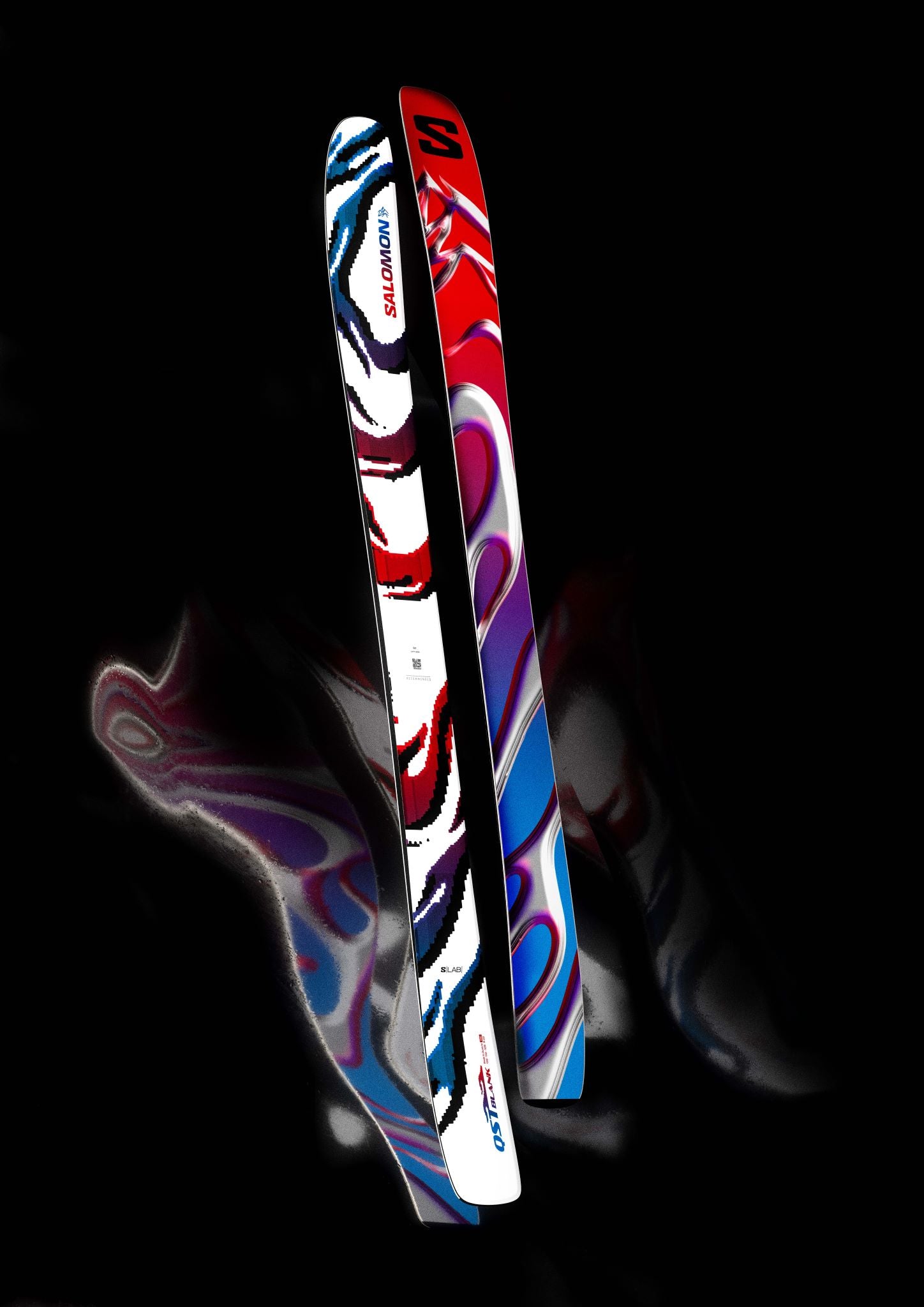 The image shows a pair of Salomon S/Lab QST Blank skis, which are designed for 2026. The skis have a vibrant and colorful design with multiple colors including red, blue, white, and black. They feature the brand name "Salomon" prominently displayed on them. These skis are likely intended for downhill skiing, given their shape and design.