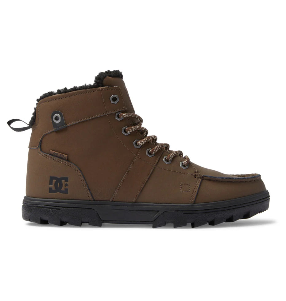 DC Woodland Boots 2024 - A pair of brown boots with a rugged sole and laces, featuring a small black logo on the side.