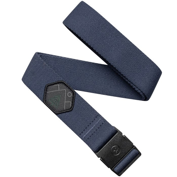 A navy blue belt with a black buckle, featuring a small patch near the buckle. The patch has a design of a stylized tree and geometric shapes. The belt is neatly arranged with the buckle prominently displayed.