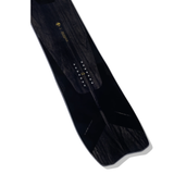 Arbor Bryan Iguchi Pro Snowboard 2026 - A black snowboard with a yellow logo and white lettering on top, featuring a wood grain pattern.