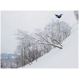 Burton Family Tree High Fidelity Snowboard 2025 - A snowboarder in a black jacket and pants is seen from above, riding down a snowy slope with their arms outstretched.