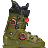 The image shows a pair of K2 Cortex 130 Zonal BOA ski boots for the year 2026. The boots are green and black, with white accents on the straps. They feature a zonal BOA closure system, which allows for adjustable fit and comfort. Additionally, there is a red tag attached to one of the boots, indicating it's new or has been recently purchased.