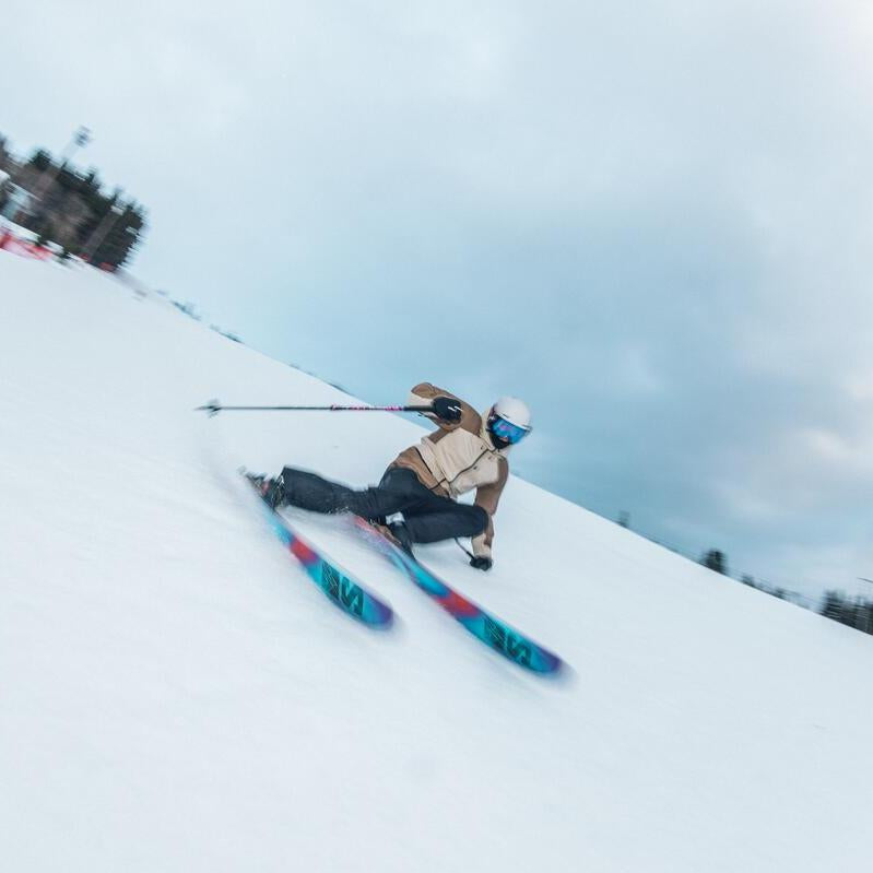 Salomon QST 98 Skis 2025 - White skis with red and blue accents, featuring a distinctive black stripe along the top edge.