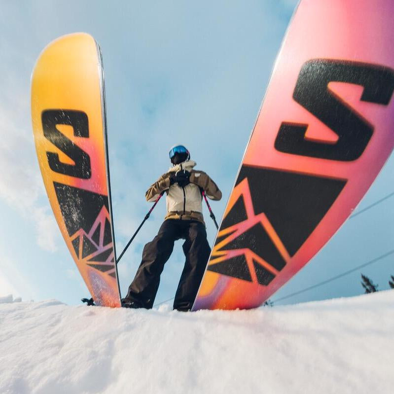 Salomon QST 106 Skis - 2025 model skis with a black and yellow color scheme, featuring a distinctive "S" logo on the top of each ski.