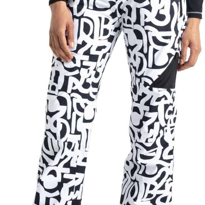 Dare2B Ladies Ice Insulated Pant 2024 - Black snow pants with a white graffiti-style pattern and black accents on the side pockets.