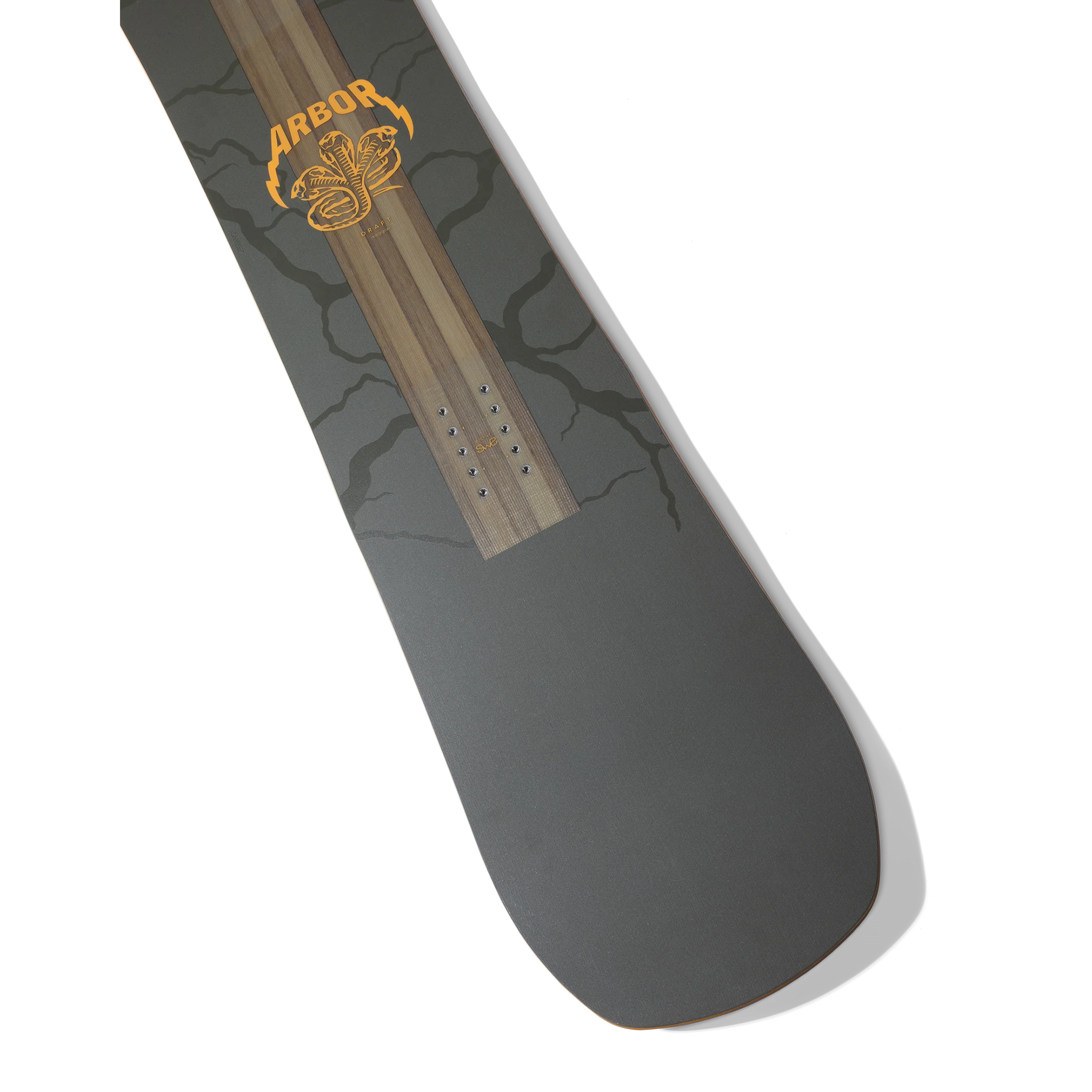Arbor Draft Snowboard 2026 - A dark gray snowboard with a black tree branch pattern and an orange logo featuring a snake coiled around a tree trunk.