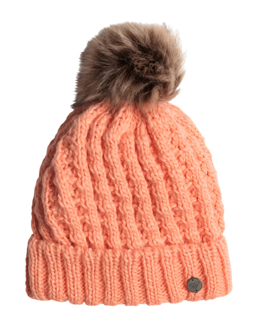 Roxy Junior's Blizzard Beanie 2025 - A salmon-colored beanie with a brown faux fur pom-pom on top.