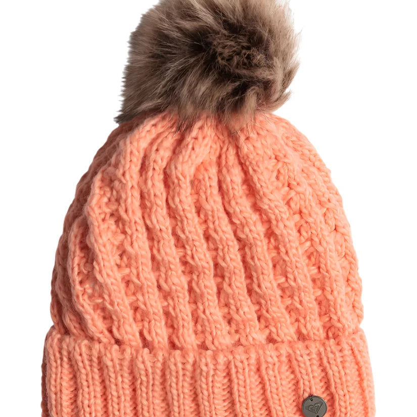 Roxy Junior's Blizzard Beanie 2025 - A salmon-colored beanie with a brown faux fur pom-pom on top.