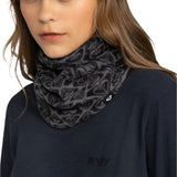 Roxy Women's Sayna Collar - A black fleece neck warmer with a repeating geometric pattern of triangles and lines in white, worn by a model with long brown hair.