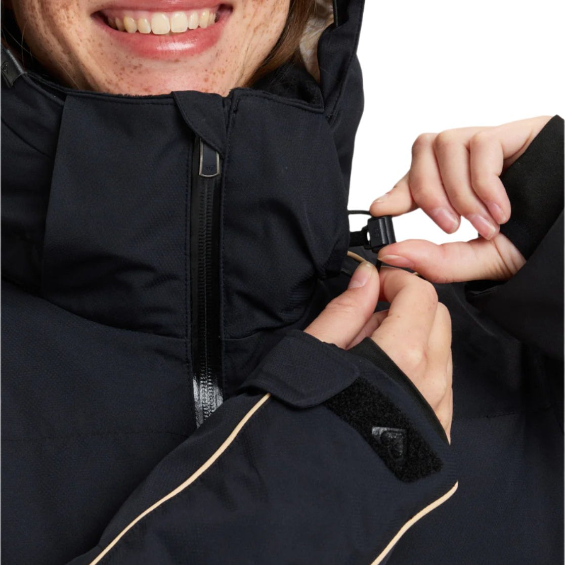 Roxy Women's Snowblizzard Insulated Jacket - A black jacket with a hood, featuring tan accents on the zipper and trim.