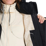 Roxy Women's Snowblizzard Insulated Jacket - A cream-colored jacket with a black hood and zipper, featuring a patterned drawstring on the hood.