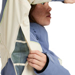 Roxy Women's Ritualized Insulated Jacket 2025 - A blue and white jacket with a zippered chest pocket, worn by a model from the side.