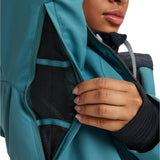 Roxy Women's Meade Insulated Jacket - A woman wearing a black and teal jacket with a hood, zipped up to her neck.