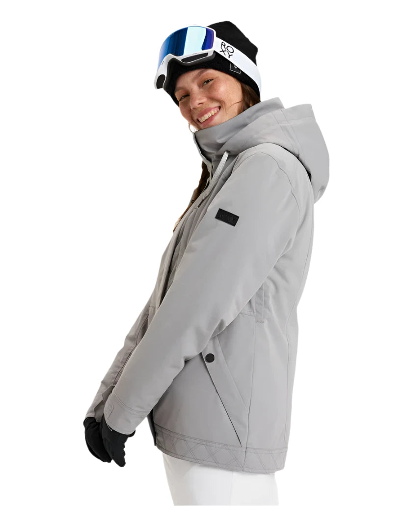 Roxy Women's Billie Insulated Jacket 2025 - A light gray jacket with a high collar and zippered pockets, featuring a black patch on the left sleeve.