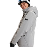 Roxy Women's Billie Insulated Jacket 2025 - A light gray jacket with a high collar and zippered pockets, featuring a black patch on the left sleeve.