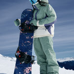 Roxy Women's Chloe Kim Insulated Pant 2025 - A navy blue snow pant with a white logo on the left thigh and a white stripe down the side of each leg.