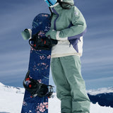 Roxy Women's Chloe Kim Insulated Pant 2025 - A navy blue snow pant with a white logo on the left thigh and a white stripe down the side of each leg.