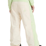 Roxy Women's Steeply Shell Pant 2025 - A pair of cream-colored snow pants with a light green stripe down the side.