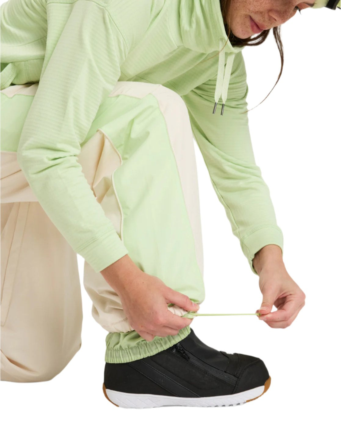 Roxy Women's Steeply Shell Pant 2025 - A pair of light green snow pants with a white stripe down the side and a zippered pocket on the thigh.