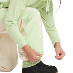 Roxy Women's Steeply Shell Pant 2025 - A pair of light green snow pants with a white stripe down the side and a zippered pocket on the thigh.