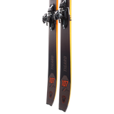 Dynafit Tigard 107 Flat Ski 2025 - A pair of black skis with orange accents and a distinctive tiger logo on the tip.