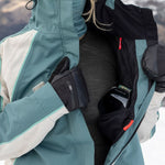 Teal colorblock shell jacket with hood, side pockets, and front zipper