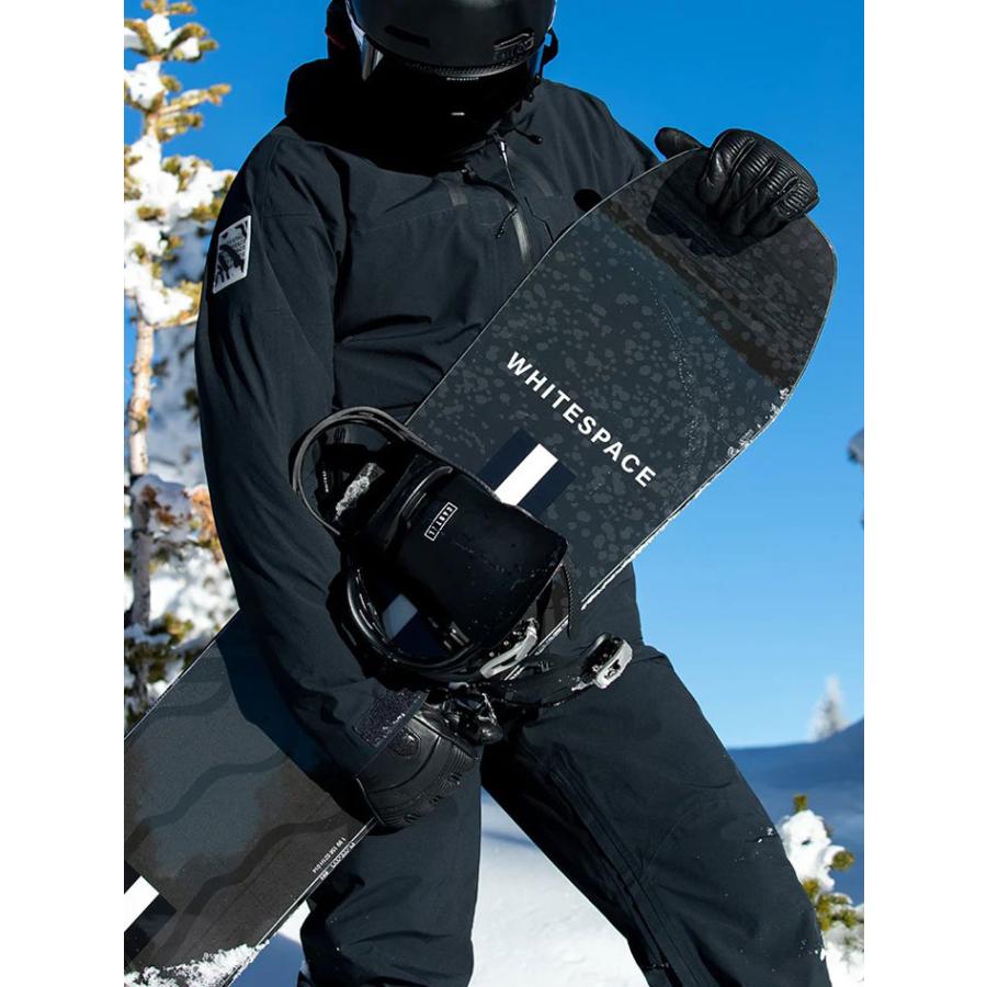 Whitespace Freestyle Shaun White Pro Limited Edition Snowboard 2023 - A black snowboard with a white stripe and "Pro" logo on top, held by a person in all-black gear.