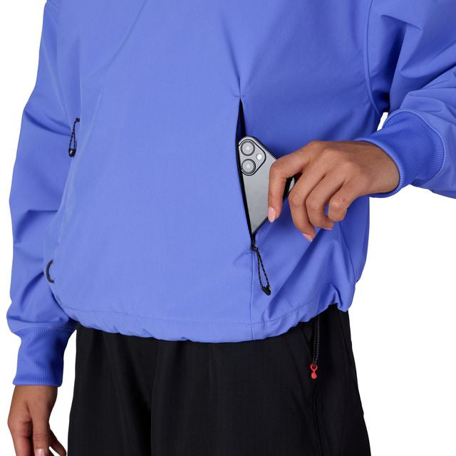 Women’s waterproof crop hoody in bright blue with front zip, hood drawstrings, zip pockets