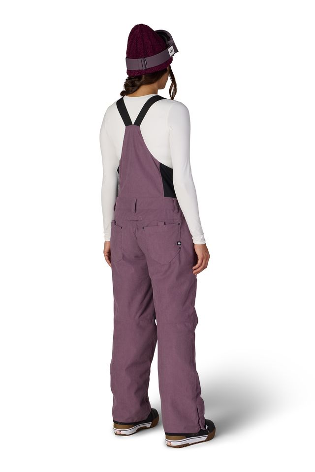 Women’s insulated bib overalls, mauve purple, back view with full suspenders and leg vents.