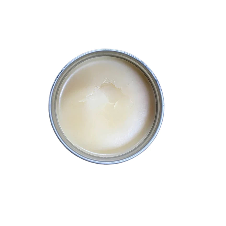Oneball Leather Waterproofing Glove Wax - A small, round tin of off-white wax with a few cracks on its surface.