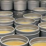 Oneball Leather Waterproofing Glove Wax - A yellowish wax in a round metal tin with a screw-top lid.