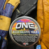 Oneball Leather Waterproofing Glove Wax - A round tin of wax with a label that says "ONE" in large white letters and "ECO GLOVE WAX" in smaller black letters underneath, on top of a leather glove.