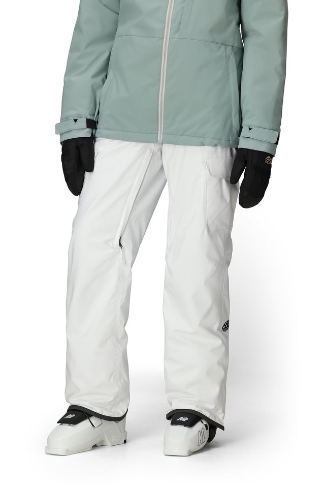 White cargo pants with adjustable cuff hem and side pockets; paired with outerwear