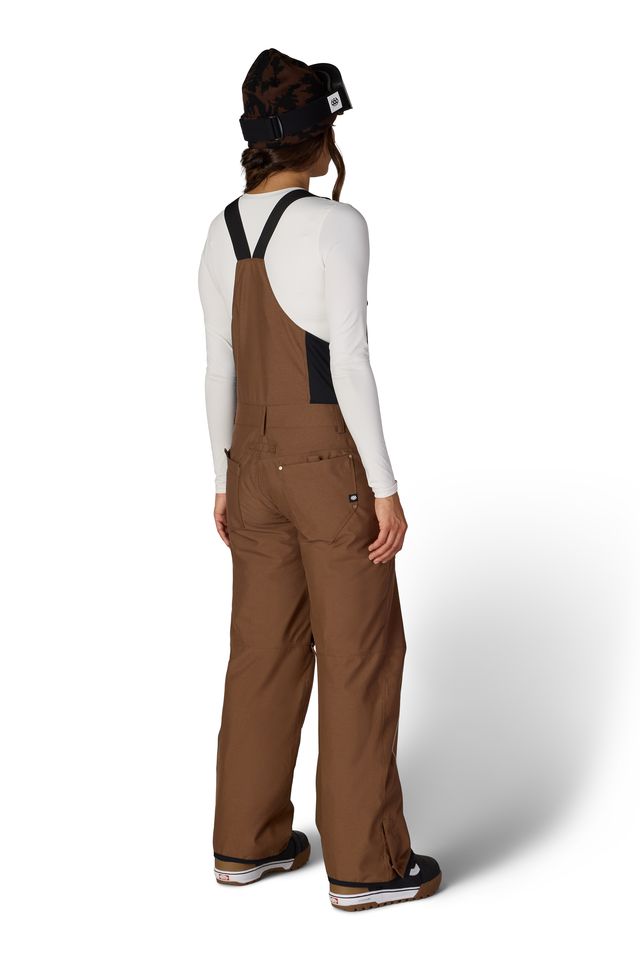 Women’s insulated brown bib overalls, back view with suspenders and ankle cuff details.