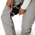 Light grey shell pants with side pocket opening and adjustable drawcord hem