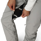 Light grey shell pants with side pocket opening and adjustable drawcord hem