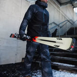 K2 Disruption MTI skis with MXC 12 bindings feature a black and red design against a snowy background.