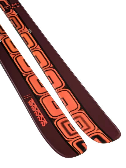 K2 Women's Omen 90 skis 2025 feature a black and red design with white graphics.