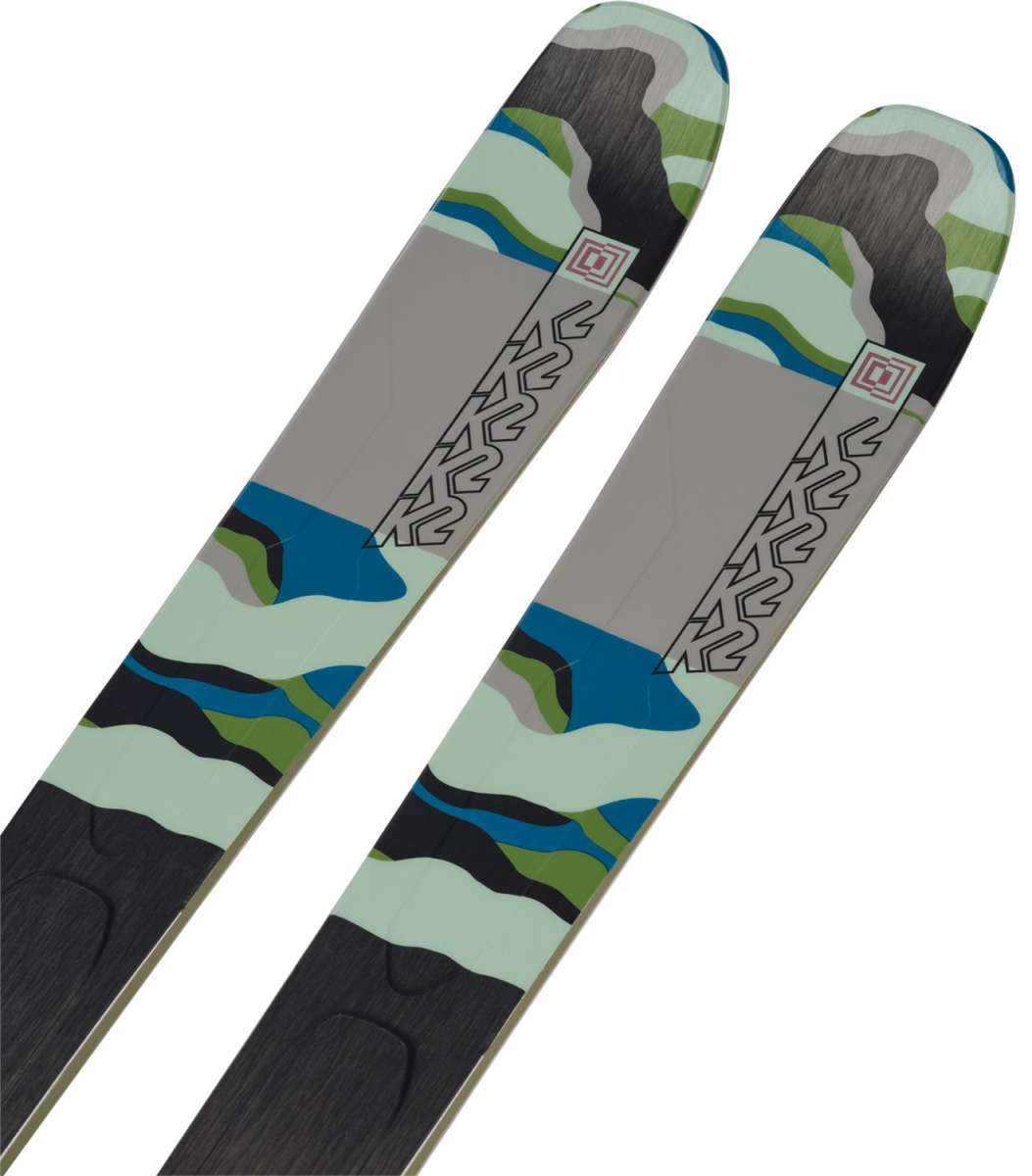 K2 Mindbender 99Ti Wide skis feature a distinctive green and blue graphic design.