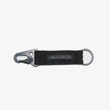 CLIP NYLON WEB KEYCHAIN 2023 - A black nylon keychain with a metal clip and ring, featuring a woven web design.