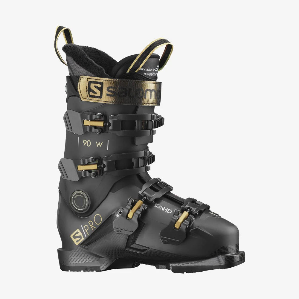 Salomon Women's S Pro 90 Ski Boots 2022 - Black ski boots with gold buckles and straps.