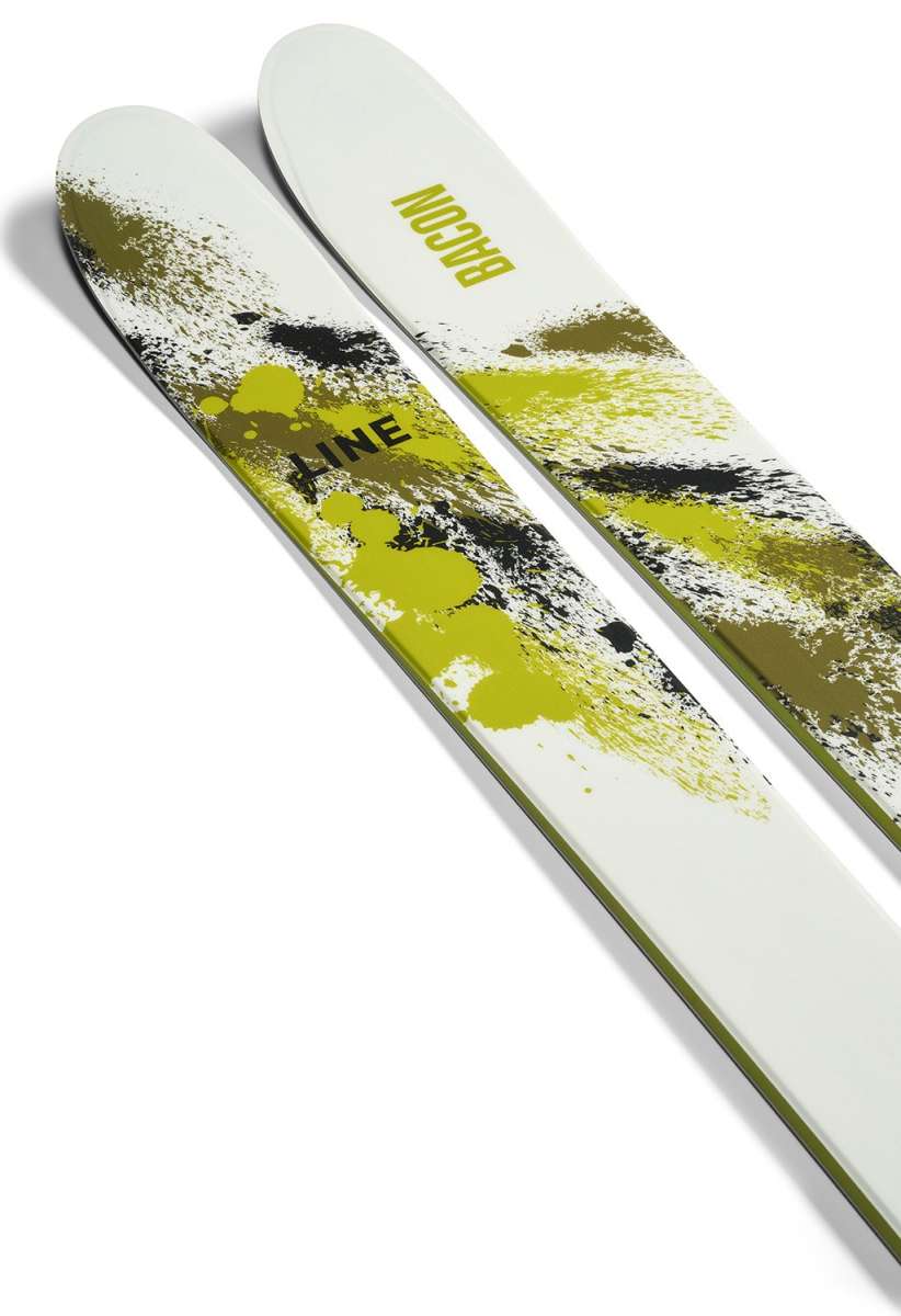 Line Bacon 115 Skis 2024 - White skis with green splatter design and black lettering.