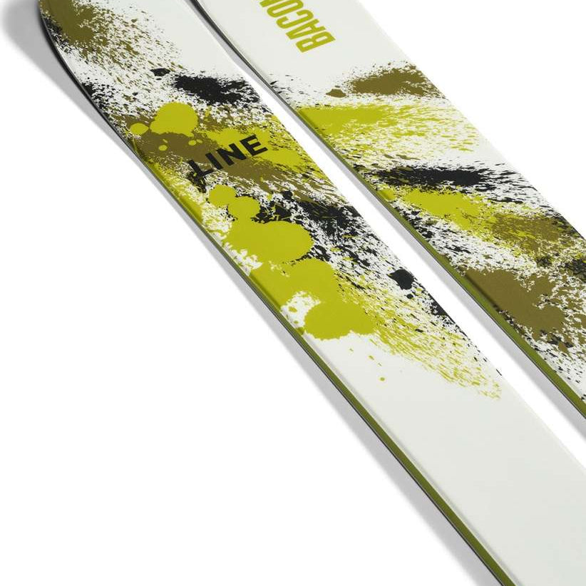 Line Bacon 115 Skis 2024 - White skis with green splatter design and black lettering.