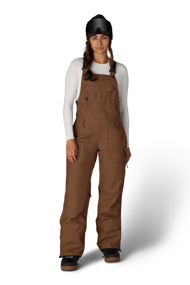 Women’s insulated bib overalls in brown with front pockets, adjustable straps, and cuff accents.