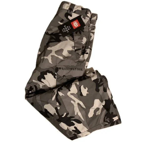 The 686 Defender Cargo Pants 2023 are showcased in this image, displaying a black and gray camouflage pattern.