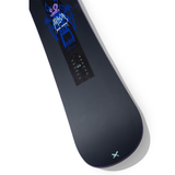 Arbor Metal Machine 2026 - A black snowboard with a blue graphic of a monster-like creature on top, wearing goggles and holding ski poles.