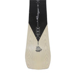Jones Flagship Pro Snowboard 2025 - A black snowboard with a white logo and text on top of a light-colored wood grain background.