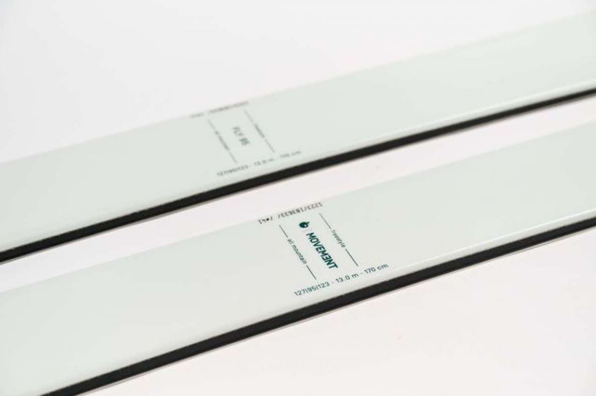 Movement Women's Fly 95 Skis 2024 - White skis with black bindings and a black stripe down the middle.